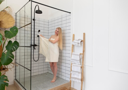 A shower with a modern built-in niche and corner rack.