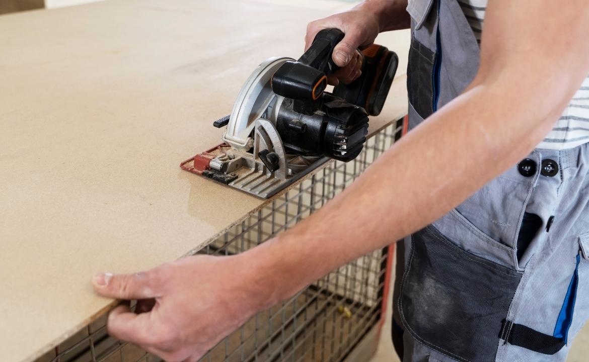 Cutting travertine tile with a wet saw for precise edges.