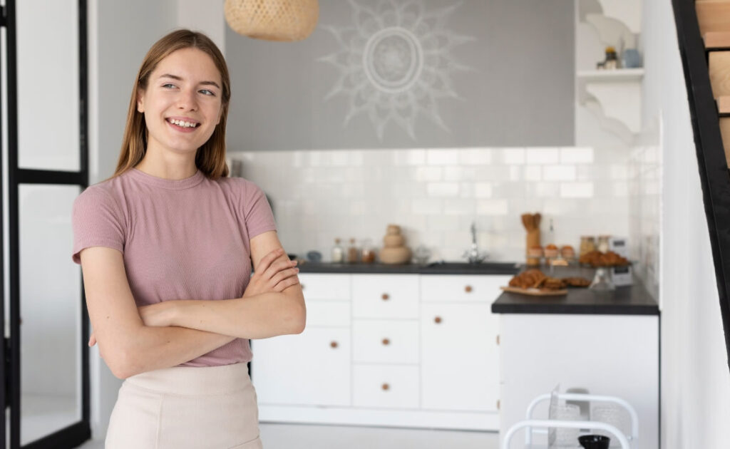 Happy homeowner standing in newly renovated Kellyville kitchen